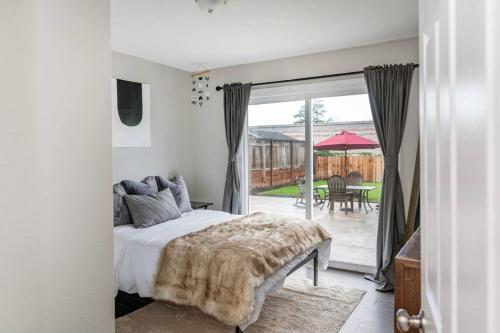a bedroom with a bed and a sliding glass door at Remodeled Home w/ King Bed, Bunk Bed, & Yard Games in Concord