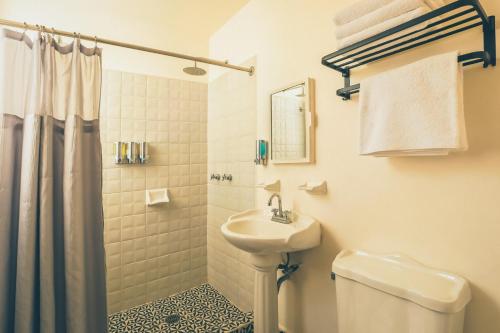 a white bathroom with a sink and a toilet at AirTabacalera in Mexico City