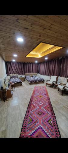 a large room with a rug on the floor at Sunset Roof apartment in Madaba