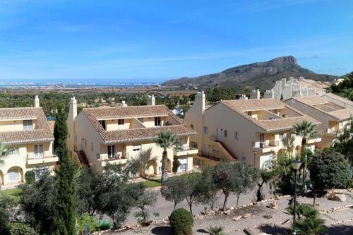 arial view of a villa with palm trees and mountains at La Manga Club Resort - Los Olivos 68 in Atamaría