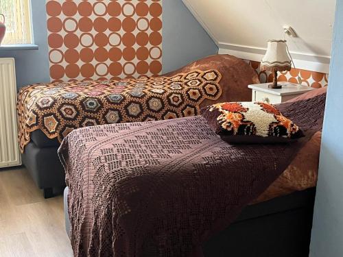 En eller flere senge i et værelse på B&B Het Oude Dorpscafé