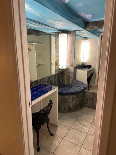a room with a sink and a mirror at Ramada by Wyndham Las Cruces Hotel & Conference Center in Las Cruces