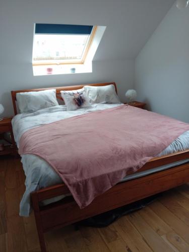 a bedroom with a large bed with a window at Ama's Sweet home in Saint-Hubert