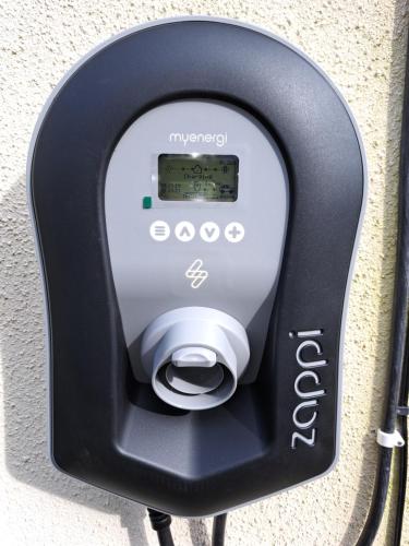 a pay phone is attached to a wall at Sycamore Lodge Kent With EV Zappi type 2, swimming pool for a fee in Sellindge