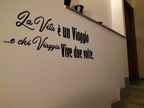 Crevoladossola的住宿－CASA REGINA，带有读取小提琴里小提琴里小提琴的标志的墙 我们