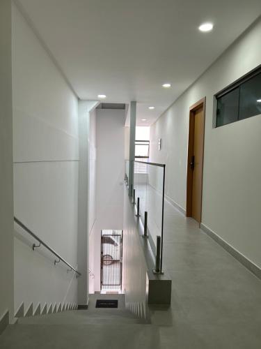 a hallway with a staircase in a building at Loft Solaris Apart Hotel - Suíte - Apt. N.103 in João Câmara