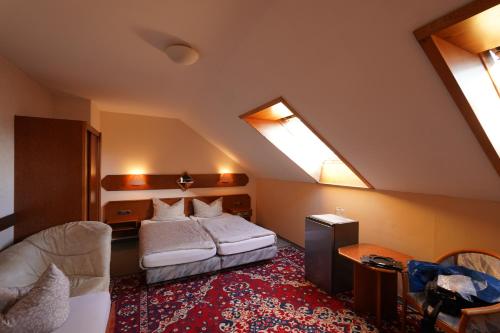 a bedroom with a bed and two skylights at Hotel Plovdiv in Berlin