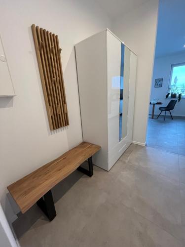 a room with a wooden bench next to a wall at Heideglück in Asendorf