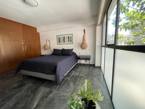a bedroom with a bed and a window at Great apartment in the heart of Coyoacan in Mexico City