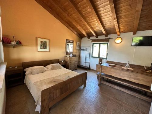 a bedroom with a bed and a bench in it at Kuća za odmor Samograd in Žrnovo