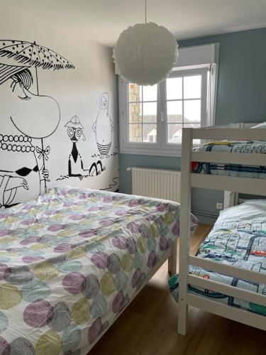 une chambre avec un lit avec une couette dans l'établissement Jolie maison à Equihen-Plage, à Équihen-Plage