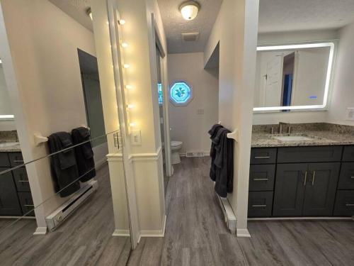 a large bathroom with a sink and a mirror at White Tail Run At Heron Hill Retreat Hot Tub Lake! in Streetsboro