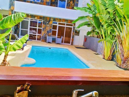a swimming pool in the middle of a house at Grand Baie Holiday Apartment in Grand Baie