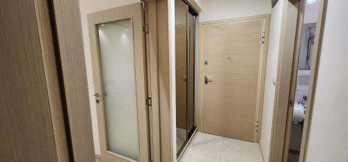 a bathroom with a mirror and a walk in closet at City apartment in Podgorica