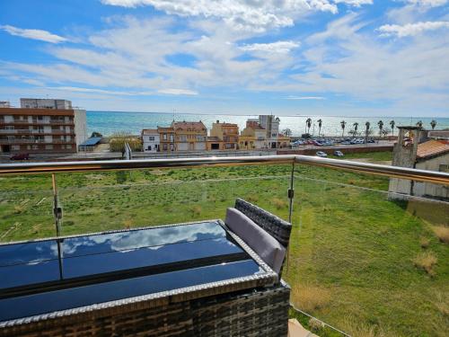 a view of the beach from the balcony of a house at Apartment Beach Front Canet in Canet de Mar