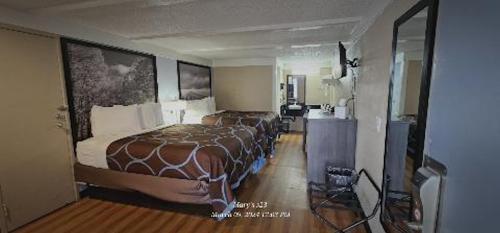 a bedroom with a large bed in a room at Super 8 by Wyndham Asheville/Biltmore in Asheville