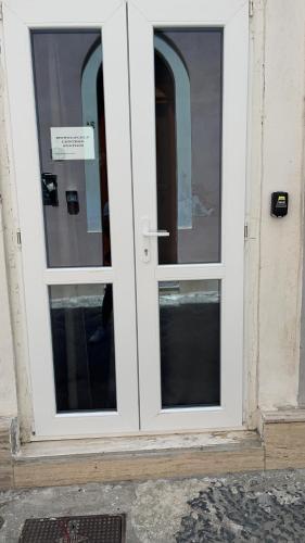 uma porta branca com três janelas num edifício em Monolocale Central Station em Brindisi