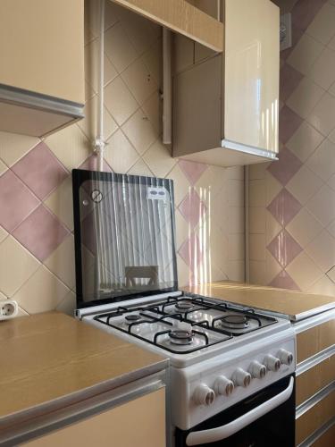 a kitchen with a stove top oven in a kitchen at Premium new Apartament in Chişinău