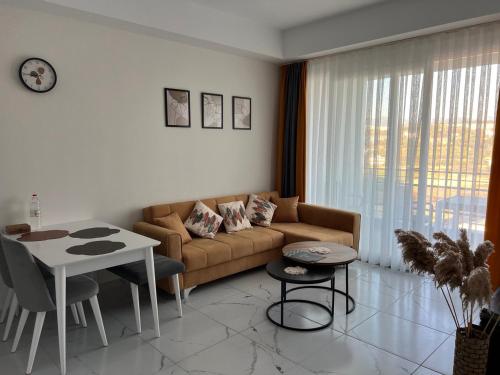 a living room with a couch and a table at Art Life apartments BOHO in Alanya