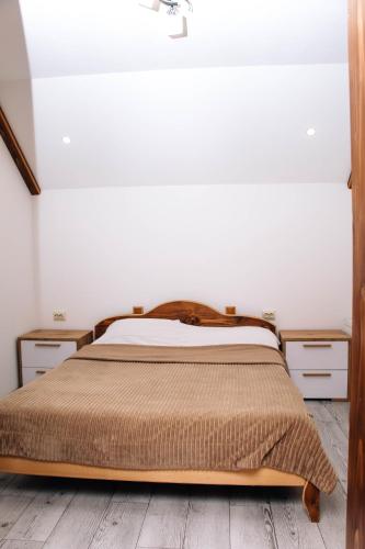 a bedroom with a bed and two night stands at Ехо Тростяну in Slavske