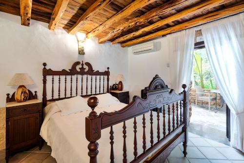 a bedroom with a bed and a large window at Agroturismo Can Gall in Sant Llorenç de Balafia