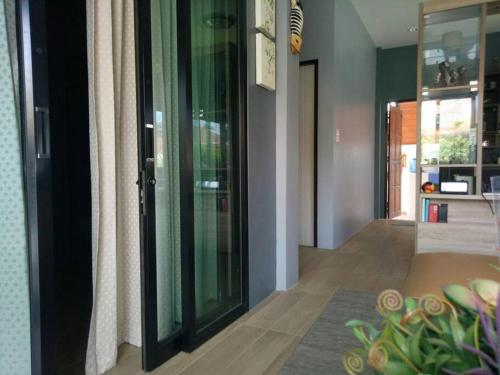 a hallway with glass doors in a house at Happy home Suratthani 152/57 in Amphoe Koksamui