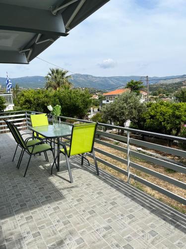 a table and chairs on a patio with a view at Ariadni's home - Einfamilienhaus mit Meerblick in Nea Stira