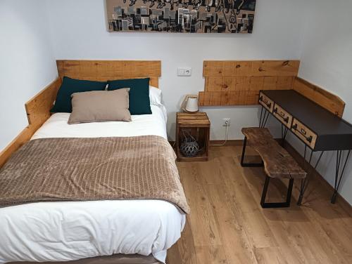 a bedroom with a large bed and a piano at Lindo pisito in León