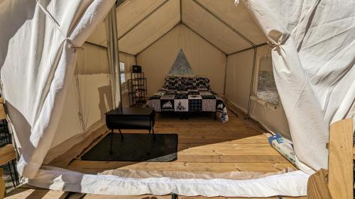 a inside of a tent with a bed in it at A Peace of Heaven Cabins and RV in Vanderpool