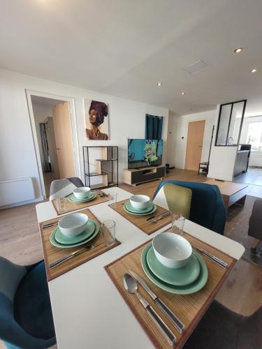 d'un salon avec une table et des plaques de cuisson. dans l'établissement Appartement hyper-centre, à Saint-Nazaire