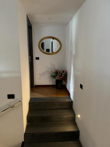 a stairway with a mirror and a vase of flowers at Kalos Relais in Catanzaro