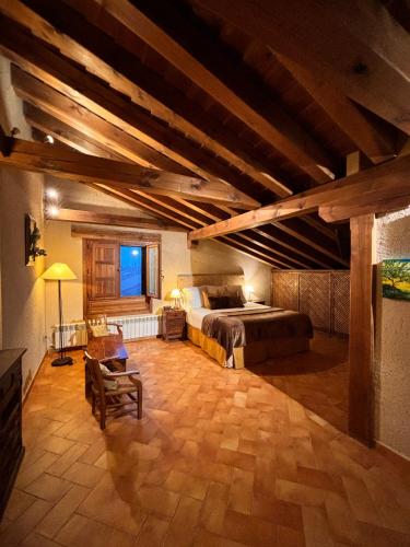 a bedroom with a bed in a room with wooden ceilings at Casa Rural Abuelo Regino in Segovia