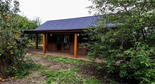 a small cabin with a porch in the woods at Not-available in Stixwould