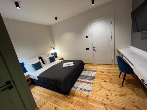 a bedroom with a bed and a desk and a bed sidx sidx sidx at Arevaham Boutique Hotel in Stepʼanavan