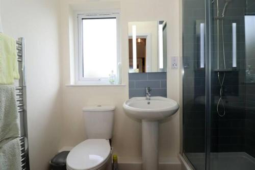 a bathroom with a toilet and a sink and a shower at Not-available in Stixwould