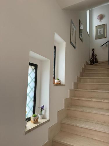 a staircase in a home with a window and a stair case at Lilly & Gisa casa vacanze in Pedara