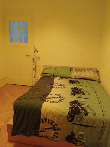 a bedroom with a bed with a motorcycle on it at JIMOBA PLACE in La Chaux-de-Fonds