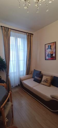 a bed in a room with a large window at Evasion du Stade in Saint-Denis