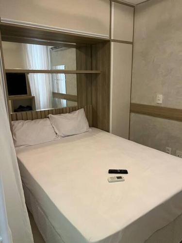 a bed in a room with at Flat que acomoda até 4 pessoas Boa Viagem-Recife in Recife