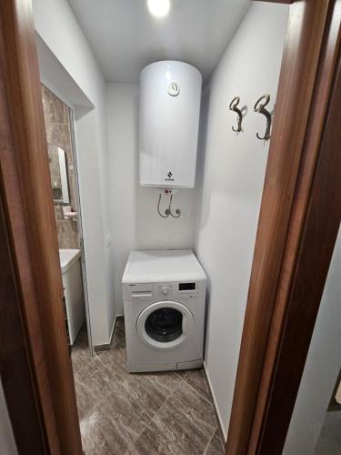 a small bathroom with a washing machine in it at Descho in Burgas City