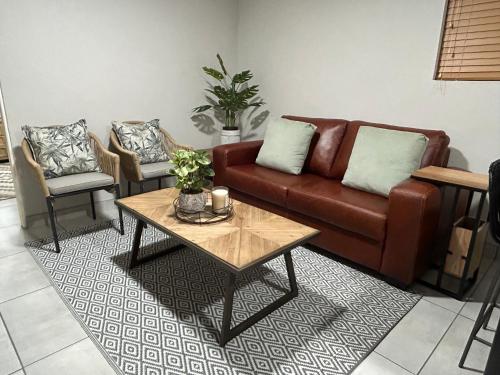 a living room with a couch and a coffee table at Hansen@15 Self Catering Studio in Piet Retief