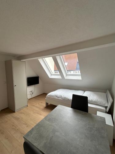 a living room with a bed and a window at Ferienwohnungen in Heidenheim in Heidenheim an der Brenz