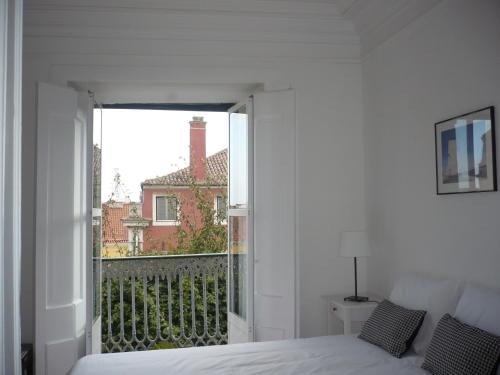 a bedroom with a bed and a large window at Olival 178 in Lisbon