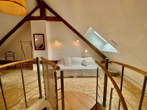 a bedroom with a bed in a attic at La Crémesine in Baratier