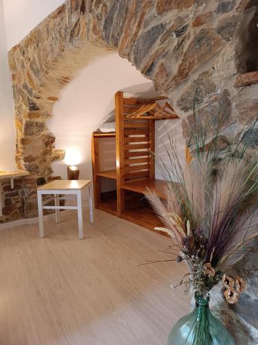 a room with a bed and a table and a vase at La Borgata in Tovo San Giacomo