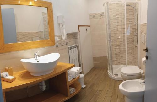 a bathroom with a sink and a toilet and a shower at La Borgata in Tovo San Giacomo