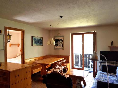 a living room with a wooden table and a couch at Appartamento Valdobbia in Gressoney-Saint-Jean