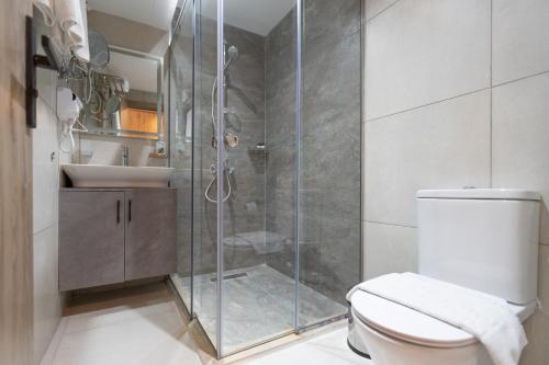 a bathroom with a shower and a toilet and a sink at Soul Pyramids View in Cairo