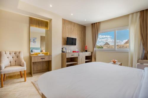 a hotel room with a large bed and a window at Soul Pyramids View in Cairo