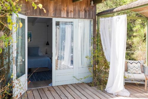 a porch with a door open to a bedroom at ES CUCONS RURAL HOTEL in San Antonio